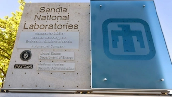 Sandia National Laboratories sign displayed on building panel, indicating federal research role.