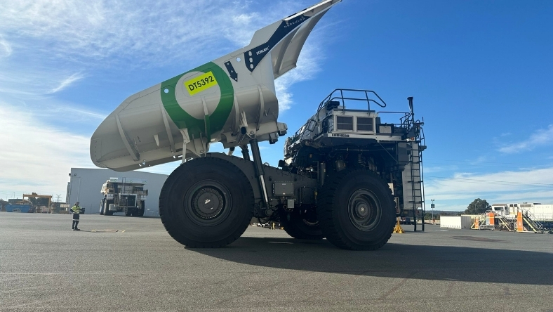 Large hydrogen haul truck parked on site with raised tanker body during pilot testing